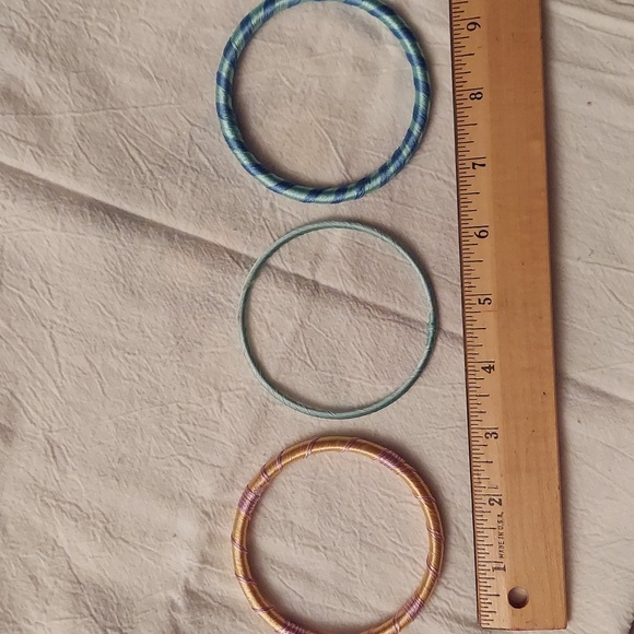 3 yarn bracelets. 1 orange/lavender, 1 green/blue, 1 mint green. - Picture 2 of 5